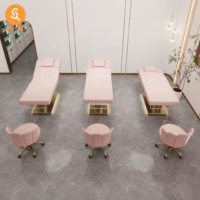 Lit de massage de beauté en cuir rose à 4 moteurs de luxe avec base en acier inoxydable à double cylindre